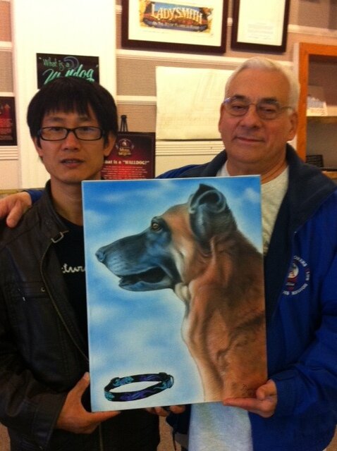 Client with a finished hand-painted dog portrait