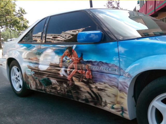 Car airbrushed with a horse and landscape scene