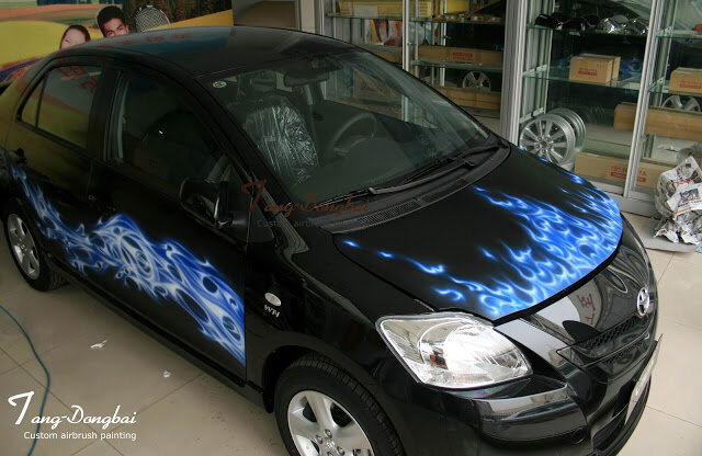 Black car with blue flame airbrush art